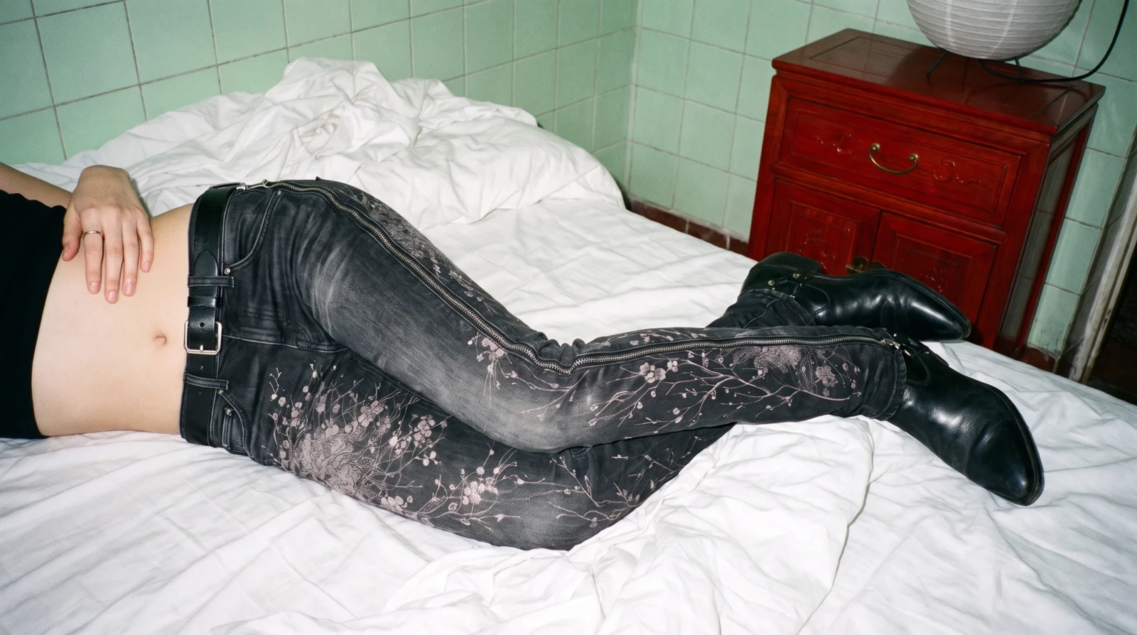 K03 KAI mid rise convertible jean, lying on a bed, the full-length zip down the outside of the leg